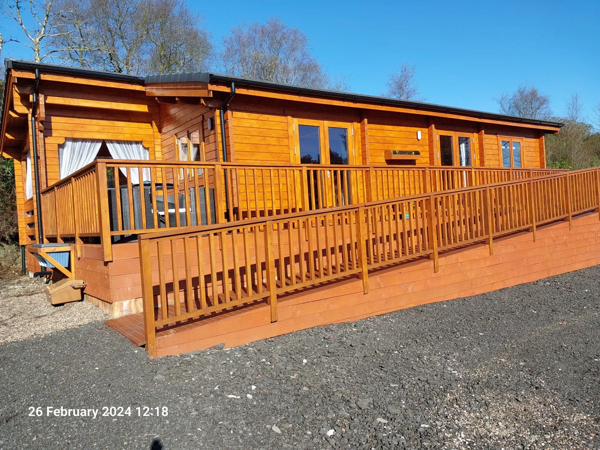 Little Lodge and decking in the sunshine at Torwood Country Lodges